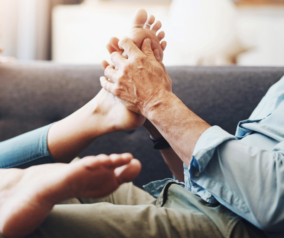 man massaging woman's foot