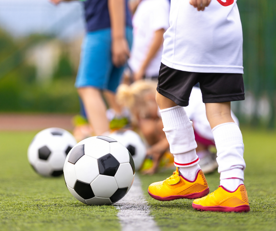 kids kicking a soccer ball